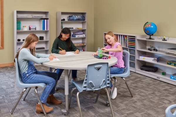 Three middle school girls at table studying