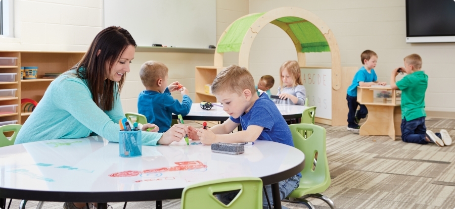 classroom of young children using dry erase furniture